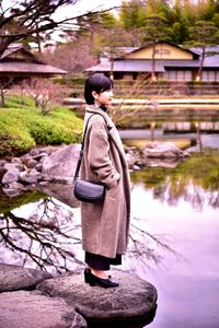 Side view of woman looking at lake