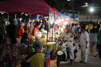 Group of people in market at night