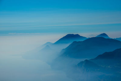 Scenic view of mountains against blue sky