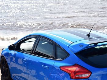 Close-up of vintage car on beach