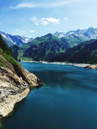 Scenic view of lake and mountains against sky