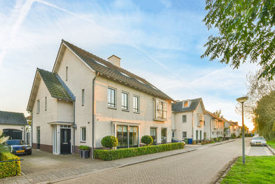 Street amidst houses against sky