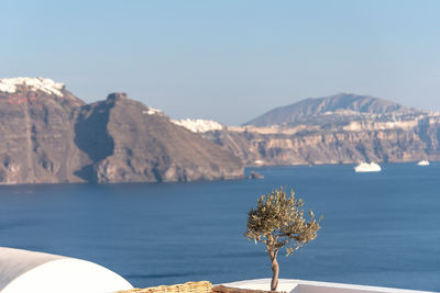 Scenic view of sea and mountains against sky