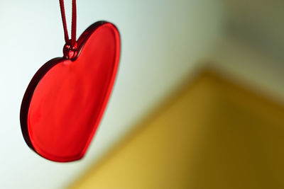 Close-up of red heart shape hanging on ceiling