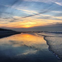 Scenic view of beach against sky during sunset