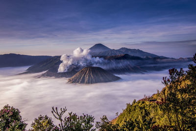 View of volcanic mountains against cloudy sky