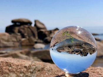 Close-up of crystal ball on rock
