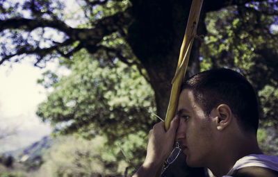 Close-up of mid adult man in tree