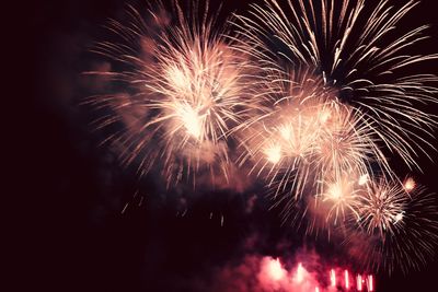 Low angle view of firework display at night