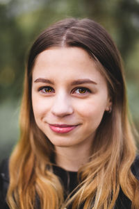 Close-up portrait of a smiling young woman