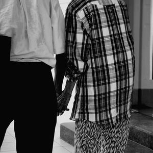 Rear view of man holding woman standing in corridor
