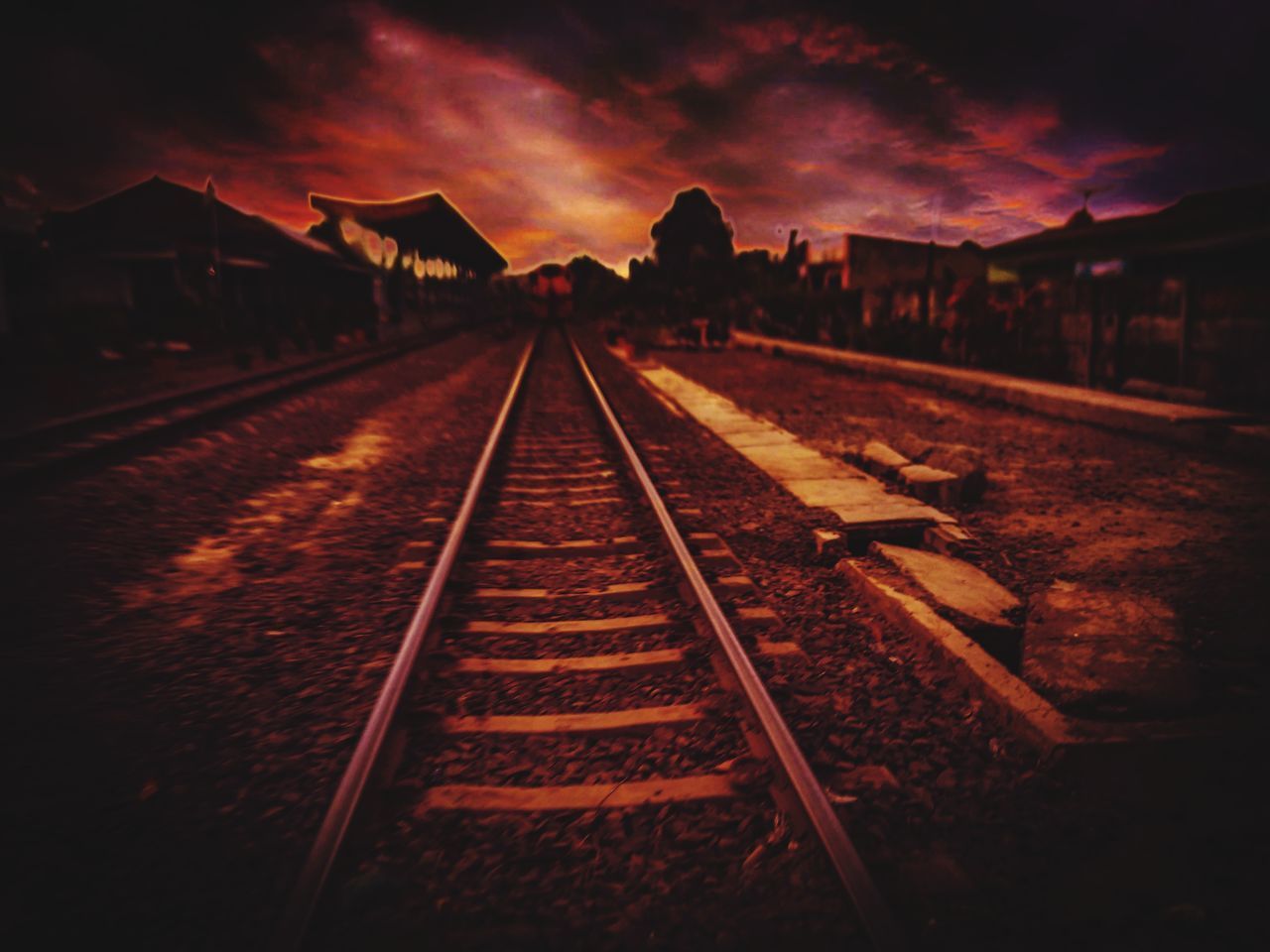 RAILROAD TRACKS AGAINST SKY DURING SUNSET