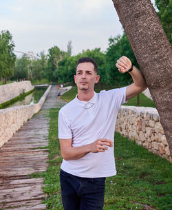 Portrait of young man standing on boardwalk