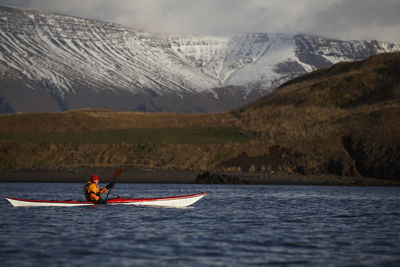 Mature man kayaking around reykjavik