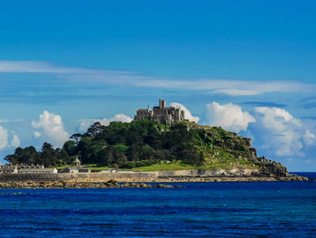 Scenic view of sea by building against sky