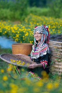 Full length of woman holding yellow flower