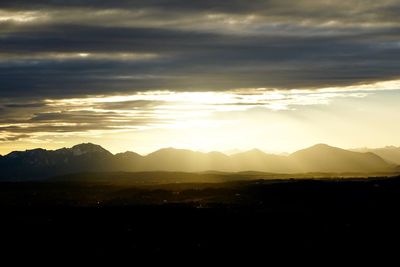 Scenic view of mountains against cloudy sky