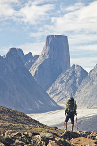 Rear view of hiker approaching mount asgard akshayak pass, canada