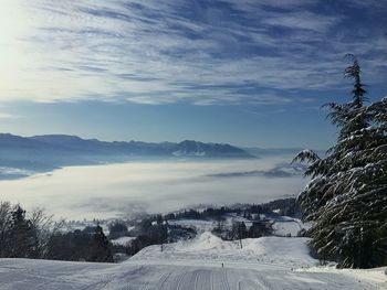 Scenic view of snow covered landscape against dramatic sky