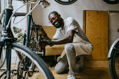 Side view of young man cycling on bicycle