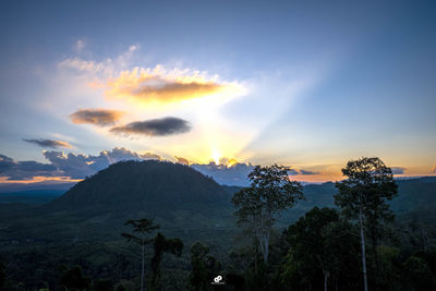 Scenic view of silhouette mountains against sky at sunset