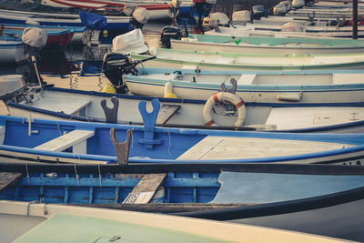 Rear view of man sitting at harbor