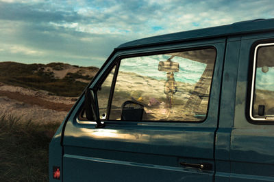 Reflection of cloudy sky on vehicle window