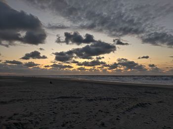 Scenic view of beach against sky during sunset