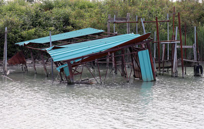 Empty chairs and table by lake