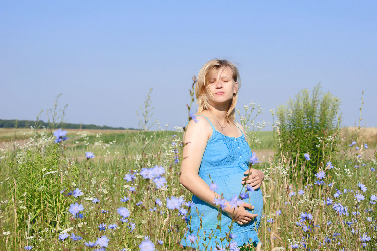 clear sky, person, leisure activity, casual clothing, lifestyles, blue, field, grass, smiling, plant, childhood, portrait, copy space, front view, growth, young adult, looking at camera, elementary age