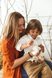 Easter kids playing with rabbits and ducks