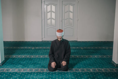 Young man praying in mosque