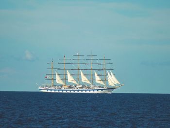 Sailboat sailing in sea against sky