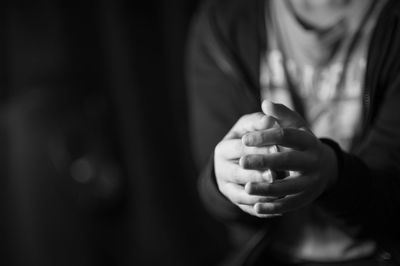 Midsection of boy with hands clasped