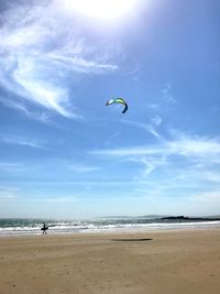 People on beach against sky