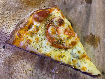 High angle view of pizza on cutting board