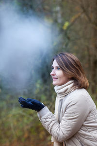 Portrait of young woman standing outdoors