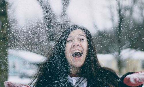 Portrait of smiling young woman in snow