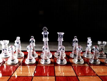 Low angle view of chess pieces against black background