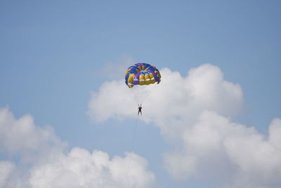 Low angle view of parachute against blue sky