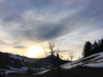 Scenic view of mountain range against cloudy sky