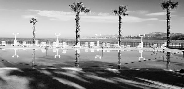 Scenic view of swimming pool by sea against sky