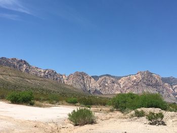 Scenic view of mountains against clear blue sky