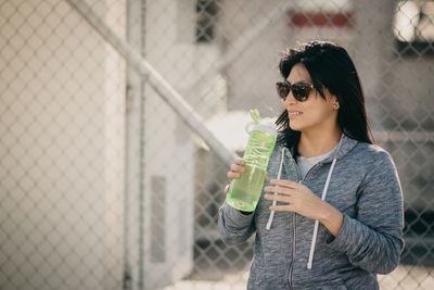 Young woman wearing sunglasses standing outdoors