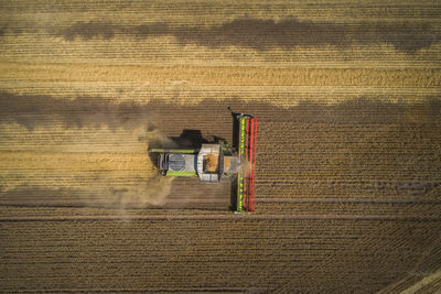 Directly above shot of combine harvester on farm