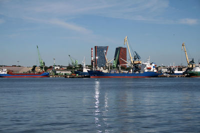 Scenic view of harbor against sky in city