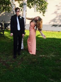 Full length of happy woman walking on lawn