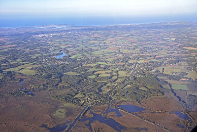 Aerial view of agricultural field against sky