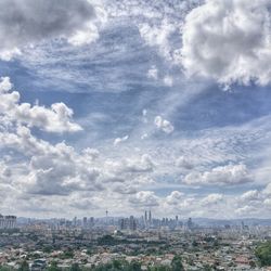 High angle view of cityscape against cloudy sky