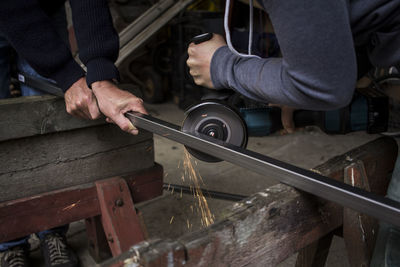 Midsection of man working in workshop